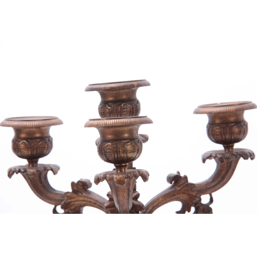 713 - A PAIR OF REGENCY STYLE FOUR BRANCH BRASS CANDELABRA with reeded tapering columns mounted on a shape... 