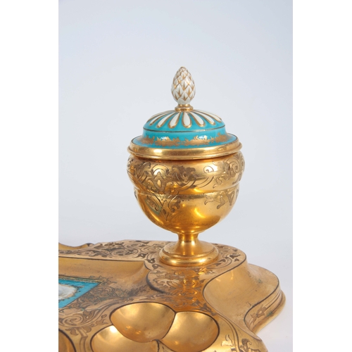 715 - A 19TH CENTURY SERVES PORCELAIN MOUNTED ORMOLU INKWELL / DESK STAND inset with a painted porcelain p... 