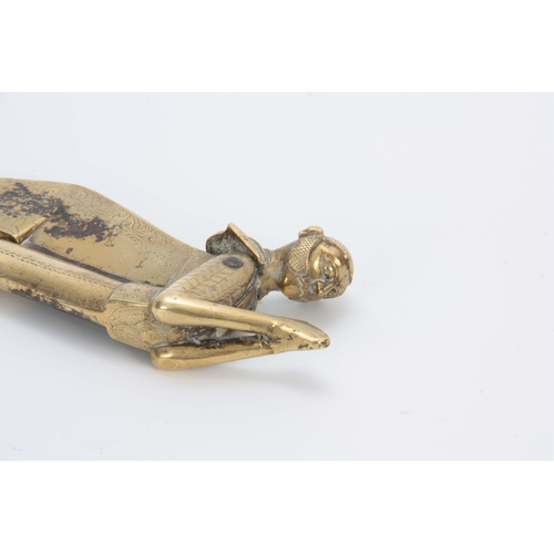 717 - A 19TH CENTURY BRASS FIGURAL BETEL NUT CUTTER with engraved decoration 21cm long 7cm wide