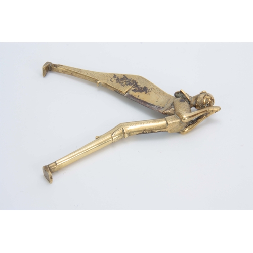 717 - A 19TH CENTURY BRASS FIGURAL BETEL NUT CUTTER with engraved decoration 21cm long 7cm wide