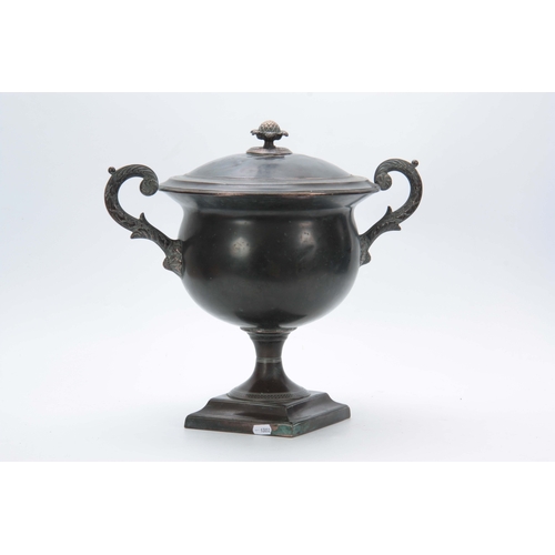 740 - A 19TH CENTURY PATINATED COPPER SAMOVAR with brass leaf cast handles and pineapple finial 39cm high.