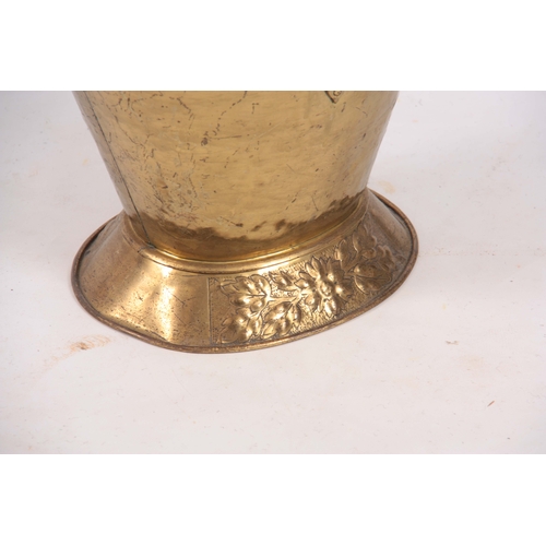 741 - A LATE VICTORIAN OVAL HOODED EMBOSSED BRASS COAL SCUTTLE of oval footed form with folding handle 49c... 