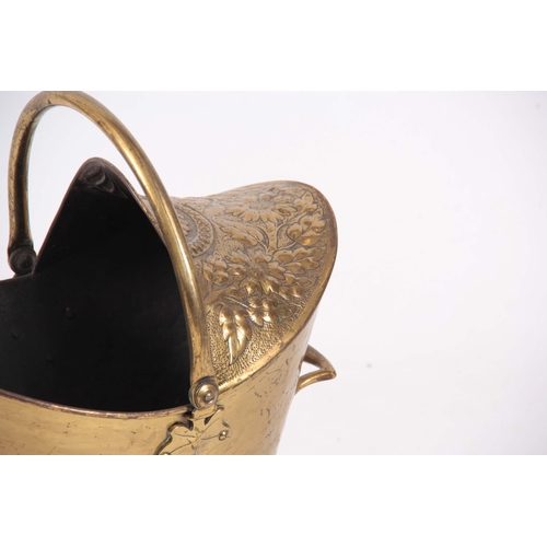 741 - A LATE VICTORIAN OVAL HOODED EMBOSSED BRASS COAL SCUTTLE of oval footed form with folding handle 49c... 