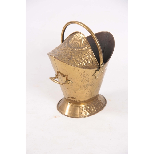 741 - A LATE VICTORIAN OVAL HOODED EMBOSSED BRASS COAL SCUTTLE of oval footed form with folding handle 49c... 