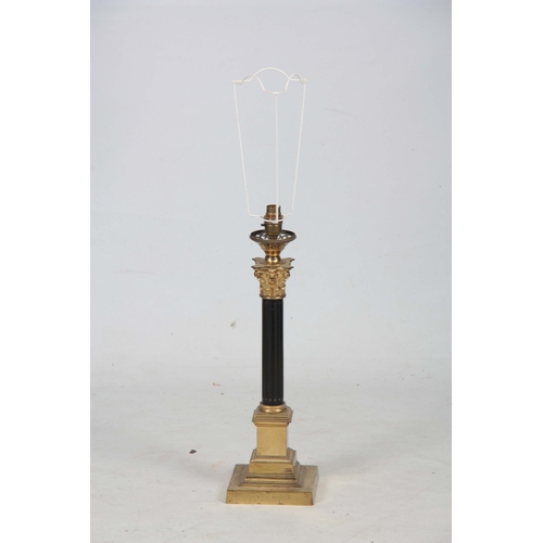 743 - A BRASS CORINTHIAN COLUMN ELECTRIFIED TABLE LAMP with reeded ebonized stem ad green pleated green sh... 