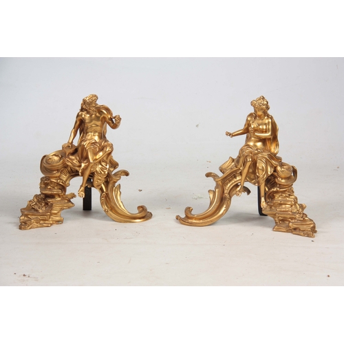 745 - A PAIR OF FRENCH 19th CENTURY ORMOLU FIGURAL CHENETS modelled as classical figures seated on rococo ... 