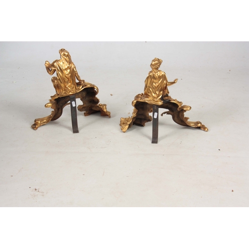 745 - A PAIR OF FRENCH 19th CENTURY ORMOLU FIGURAL CHENETS modelled as classical figures seated on rococo ... 