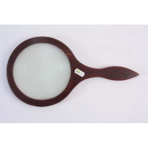 755 - A 19TH CENTURY MAHOGANY LIBRARY MAGNIFYING GLASS, the lens 14cm diameter, the frame 32.5cm long.