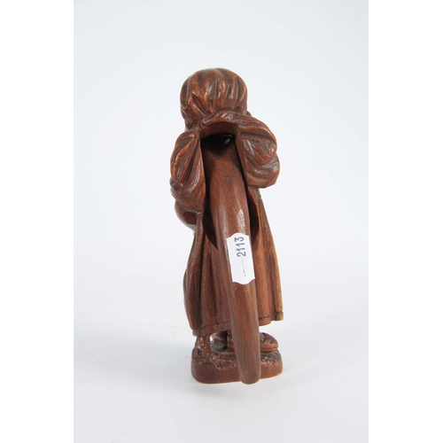 869 - A LATE 19TH CENTURY SWISS BLACK FOREST NUTCRACKER formed as an old woman with headscarf and glasses,... 