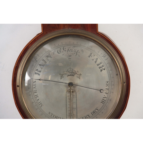 1027 - FRANCIS WEST. LONDON. A GEORGE III FIGURED MAHOGANY WHEEL BAROMETER WITH CLOCK the round top case wi... 