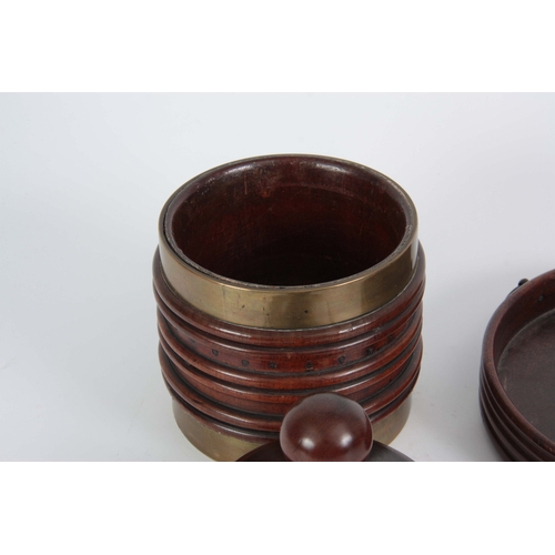 922 - A LATE GEORGIAN BRASS BOUND RIBBED MAHOGANY TOBACCO JAR of conical shape with ball finial to the lid... 