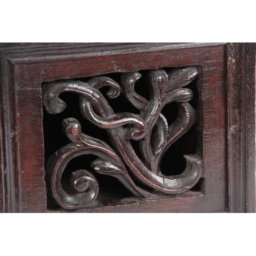 935 - AN EARLY 17TH CENTURY GOTHIC CARVED LIVERY CUPBOARD with hinged lid above a pierced leaf carved fron... 