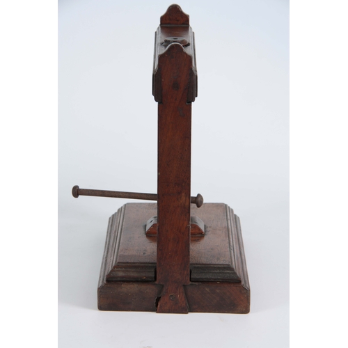 940 - AN 18TH CENTURY MAHOGANY BOOK PRESS of small proportions with central screw mechanism on raised feet... 