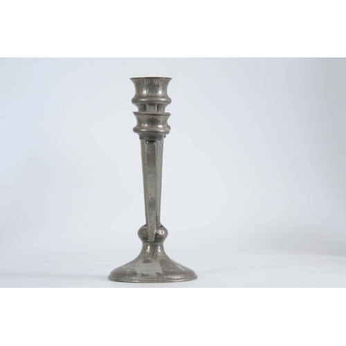 953 - A PAIR OF PEWTER ARTS & CRAFTS CANDELABRA having a hammered finish and tapered stems on circular... 