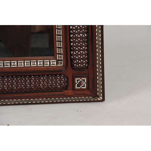 957 - AN EARLY 20TH CENTURY LIBERTY STYLE MAHOGANY MOORISH INLAID AND TURNED FRAMED MIRROR decorated with ... 