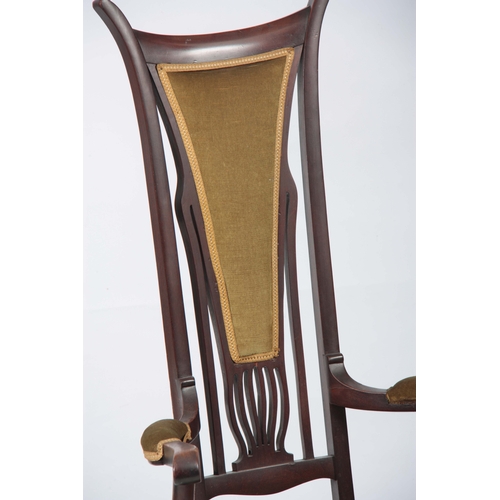 960 - AN ART NOUVEAU MAHOGANY LIBERTY STYLE OPEN ARMCHAIR with stylised shaped back and sweeping arms; sta... 