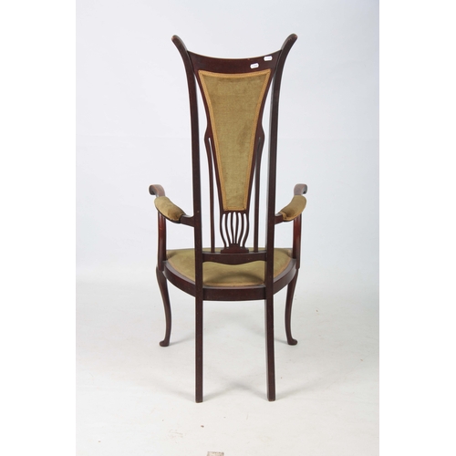 960 - AN ART NOUVEAU MAHOGANY LIBERTY STYLE OPEN ARMCHAIR with stylised shaped back and sweeping arms; sta... 