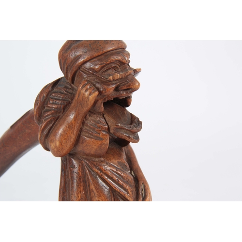 869 - A LATE 19TH CENTURY SWISS BLACK FOREST NUTCRACKER formed as an old woman with headscarf and glasses,... 