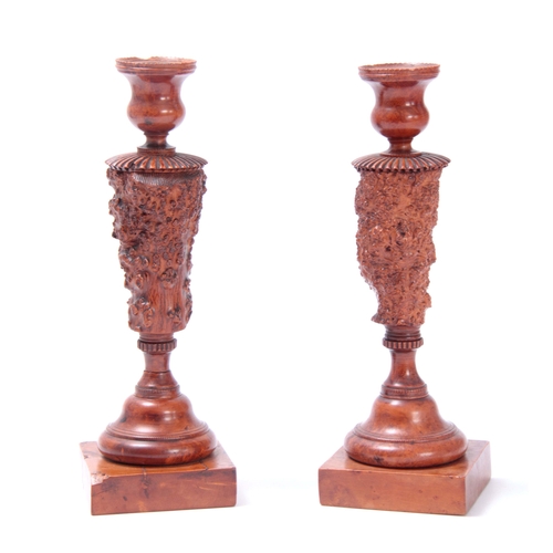 883 - AN UNUSUAL PAIR OF GEORGE III YEW WOOD TREEN CANDLESTICKS with turned square bases knotted burr wood... 