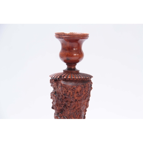 883 - AN UNUSUAL PAIR OF GEORGE III YEW WOOD TREEN CANDLESTICKS with turned square bases knotted burr wood... 