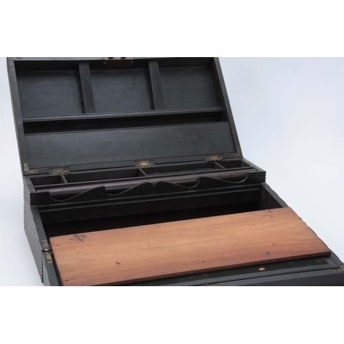 908 - A MID 19th CENTURY ANGLO-INDIAN EBONY WRITING SLOPE of ribbed design opening to reveal a fitted inte... 