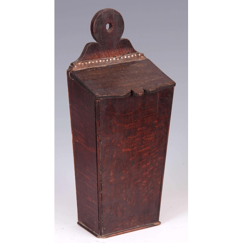 938 - A GEORGE III TAPERING OAK CANDLE BOX with ring-shaped back and hinged cover 42cm high 17.5cm wide