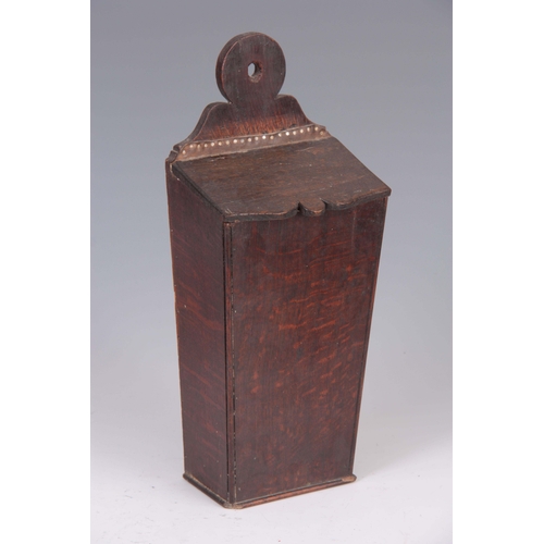 938 - A GEORGE III TAPERING OAK CANDLE BOX with ring-shaped back and hinged cover 42cm high 17.5cm wide