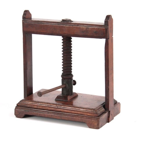 940 - AN 18TH CENTURY MAHOGANY BOOK PRESS of small proportions with central screw mechanism on raised feet... 