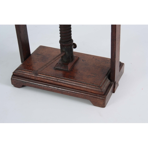 940 - AN 18TH CENTURY MAHOGANY BOOK PRESS of small proportions with central screw mechanism on raised feet... 