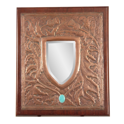 947 - AN EARLY 20th CENTURY ARTS & CRAFTS GLASGOW SCHOOL COPPER MIRROR of hammered design with thistle... 