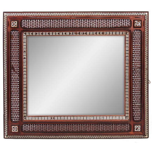 957 - AN EARLY 20TH CENTURY LIBERTY STYLE MAHOGANY MOORISH INLAID AND TURNED FRAMED MIRROR decorated with ... 