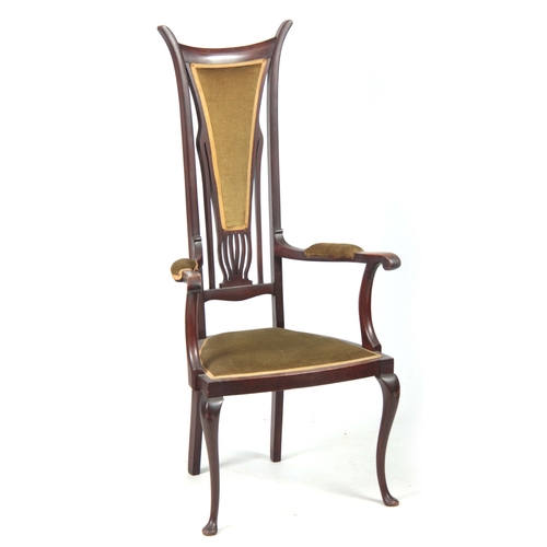 960 - AN ART NOUVEAU MAHOGANY LIBERTY STYLE OPEN ARMCHAIR with stylised shaped back and sweeping arms; sta... 