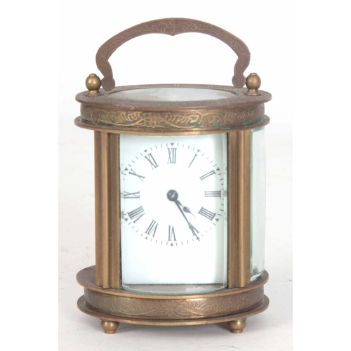 980 - A LATE 20th CENTURY OVAL CASED CARRIAGE CLOCK having chased scrollwork decoration enclosing a 40mm p... 