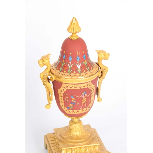 1091 - A LATE 19th CENTURY FRENCH EGYPTIAN STYLE ORMOLU AND PORCELAIN CLOCK GARNITURE the case surmounted b... 