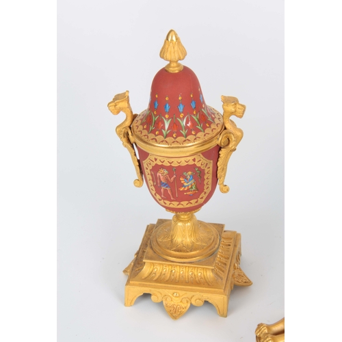 1091 - A LATE 19th CENTURY FRENCH EGYPTIAN STYLE ORMOLU AND PORCELAIN CLOCK GARNITURE the case surmounted b... 