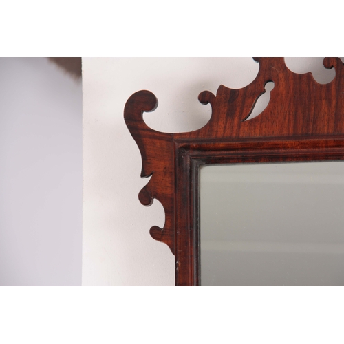 1113 - A 19TH CENTURY MAHOGANY FRET-CUT HANGING MIRROR having a rectangular mirror plate surrounded by an O... 