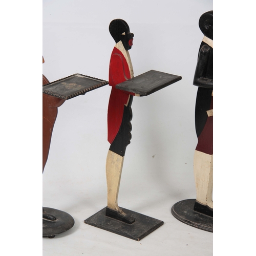 1120 - FOUR EARLY 20TH CENTURY FIGURAL DUMB WAITERS three decorated as blackamore figures and one decorated... 