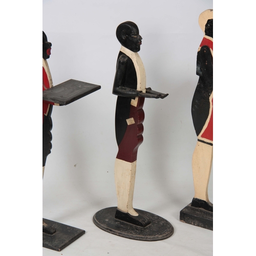 1120 - FOUR EARLY 20TH CENTURY FIGURAL DUMB WAITERS three decorated as blackamore figures and one decorated... 