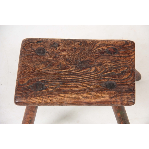 1122 - AN 18TH CENTURY OAK MILKING STOOL with thick-cut chamfered top, having traces of original green pain... 