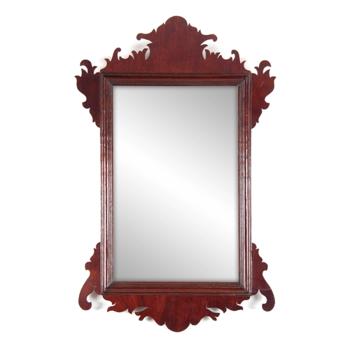 1124 - A 20TH CENTURY MAHOGANY FRET-CUT HANGING MIRROR having a rectangular mirror plate surrounded by a mo... 