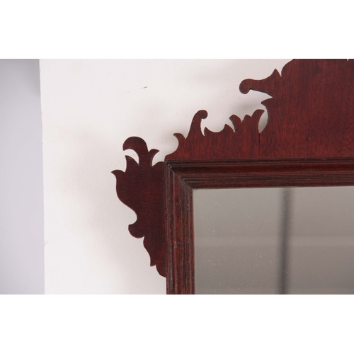 1124 - A 20TH CENTURY MAHOGANY FRET-CUT HANGING MIRROR having a rectangular mirror plate surrounded by a mo... 