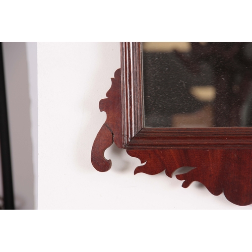 1124 - A 20TH CENTURY MAHOGANY FRET-CUT HANGING MIRROR having a rectangular mirror plate surrounded by a mo... 