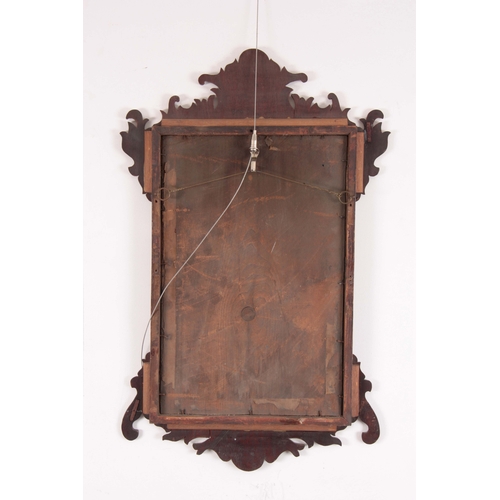 1124 - A 20TH CENTURY MAHOGANY FRET-CUT HANGING MIRROR having a rectangular mirror plate surrounded by a mo... 