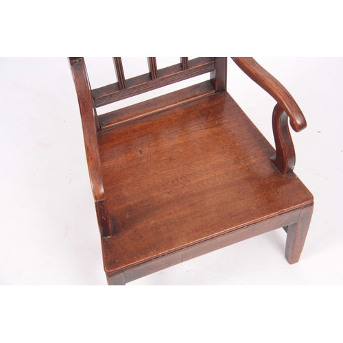 1127 - A LATE GEORGIAN FRUITWOOD CHILDS ARMCHAIR with slatted back and boarded seat; standing on tapering s... 