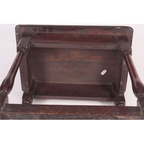 1134 - A 18TH CENTURY JOINED OAK STOOL with nailed top on a slender splayed baluster turned base with raise... 