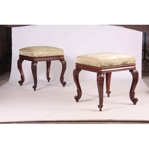 1135 - A PAIR OF LATE REGENCY ROSEWOOD STOOLS with upholstered cushion tops; standing on carved cabriole le... 