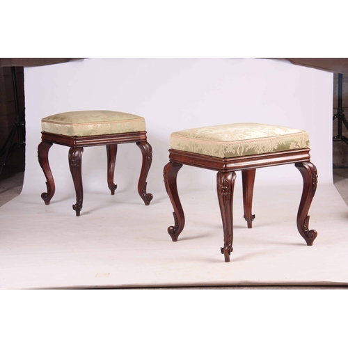 1135 - A PAIR OF LATE REGENCY ROSEWOOD STOOLS with upholstered cushion tops; standing on carved cabriole le... 