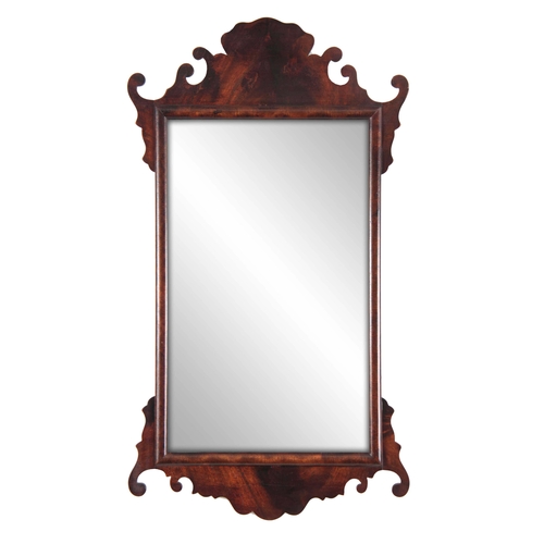 1137 - A 20TH CENTURY MAHOGANY FRET-CUT HANGING MIRROR having a rectangular mirror plate surrounded by a D ... 