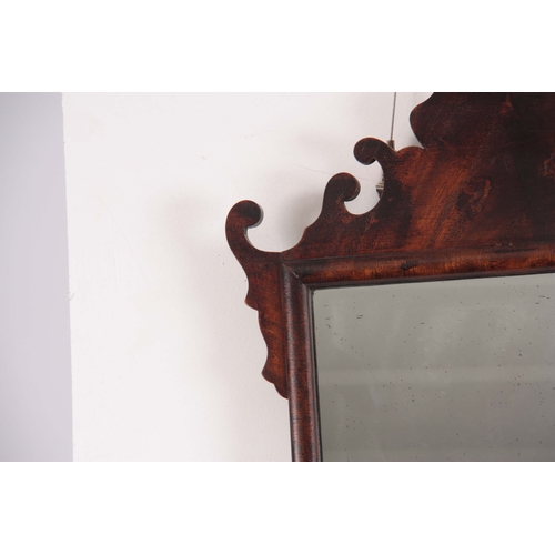 1137 - A 20TH CENTURY MAHOGANY FRET-CUT HANGING MIRROR having a rectangular mirror plate surrounded by a D ... 