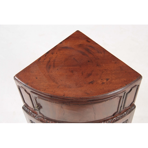 1141 - A GEORGE III MAHOGANY CORNER BEDSIDE TABLE with hinged door above a carved moulded edge, standing on... 